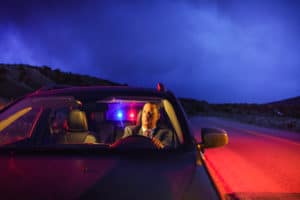 man sits in car after being pulled over for DWI