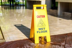 A “Caution: Wet Floor” sign on a tile floor