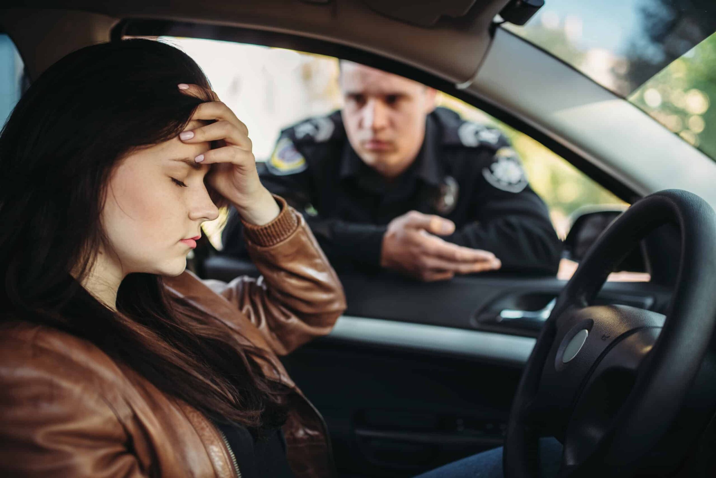 Young girl being stopped by a cop for DUI, she will need legal help to deal with the consequences
