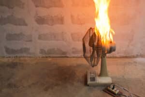 A small fan on fire due to an electrical product defect such as faulty wiring