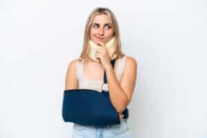 Hurt woman with a broken arm and neck brace in need of legal help for her personal injury