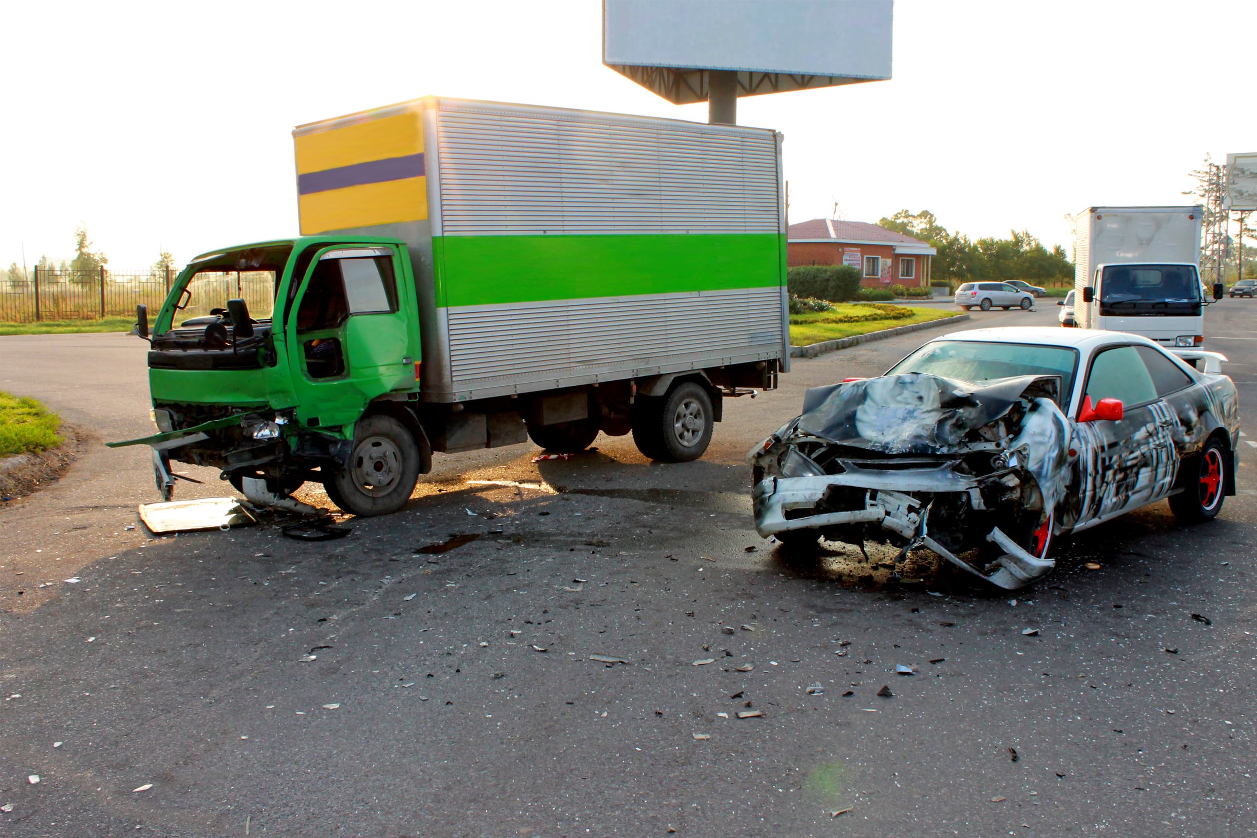 Motor vehicle accident involving two company trucks hitting a normal car, creating a confusing situation.
