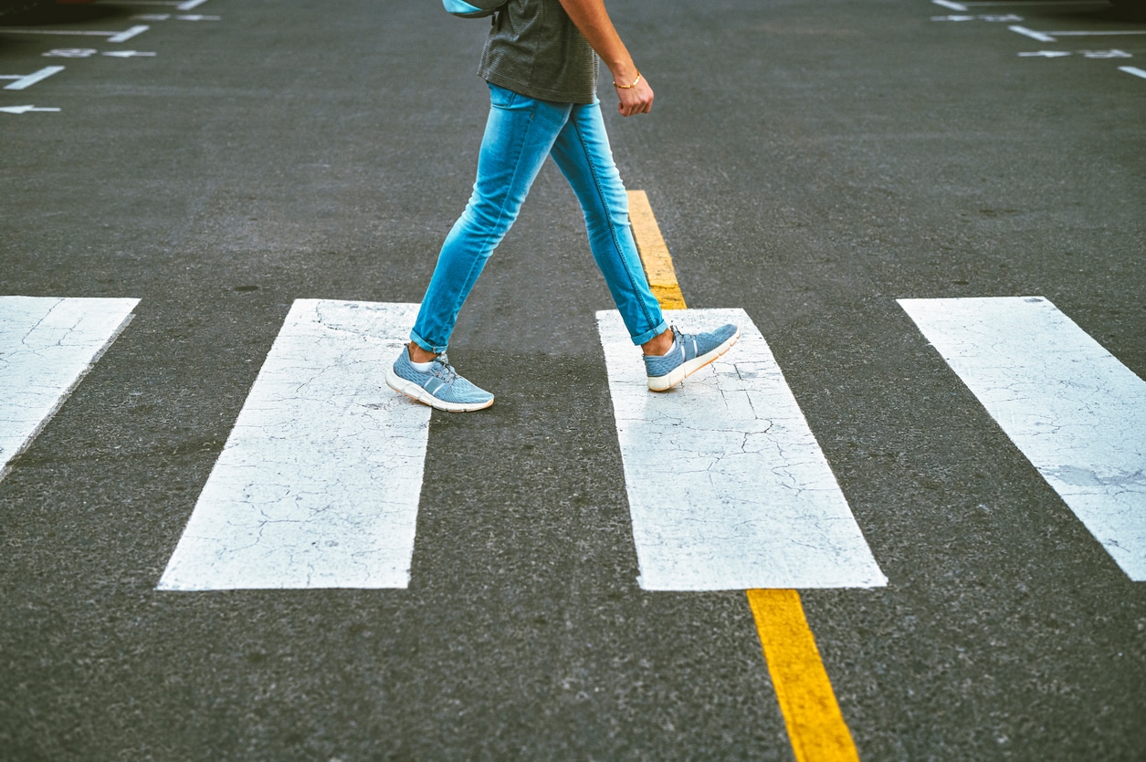 Close-up of a pedestrian walking in the cross walk before a hit-and-run accident involving a pedestrian.
